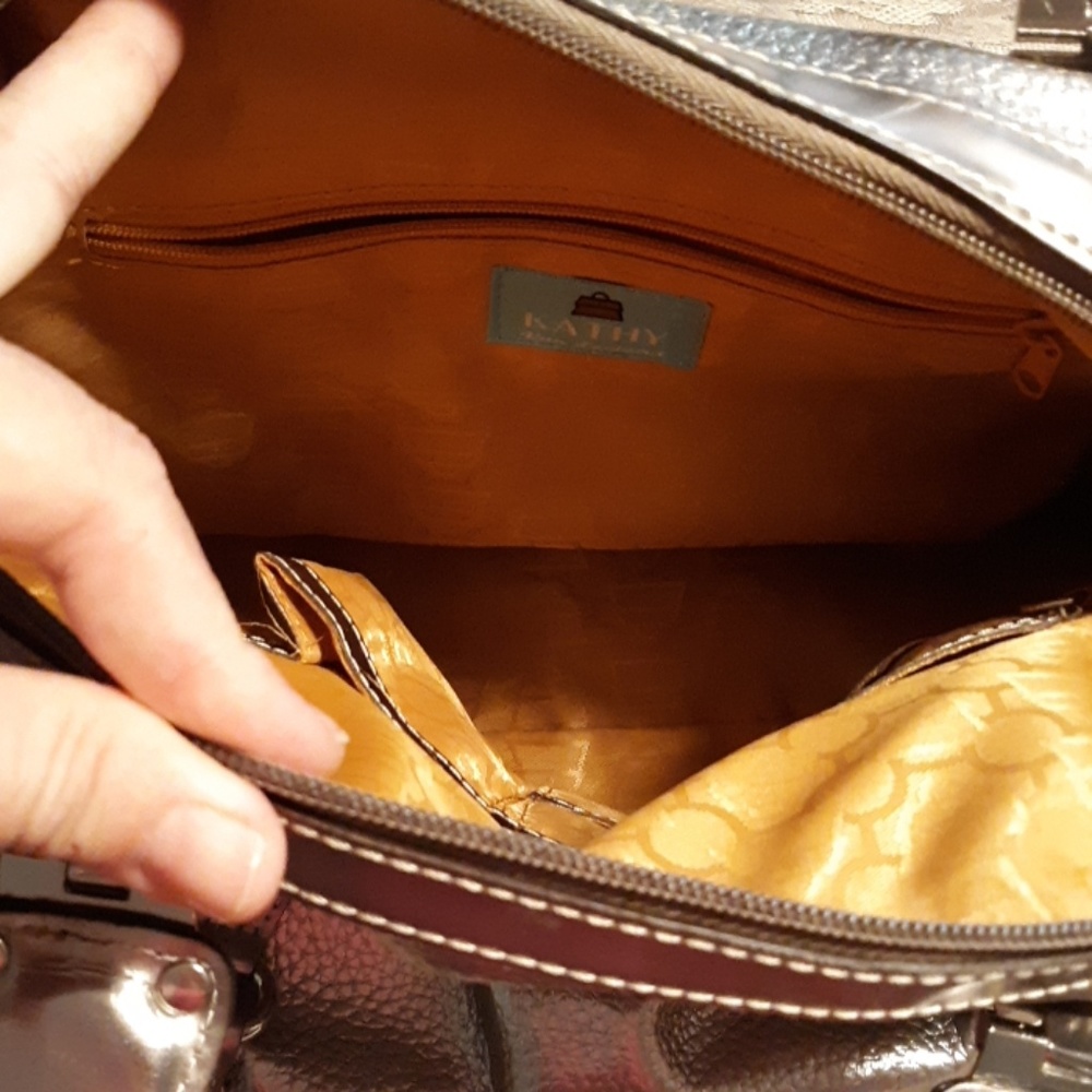 Silver pocketbook with soft gold lining.